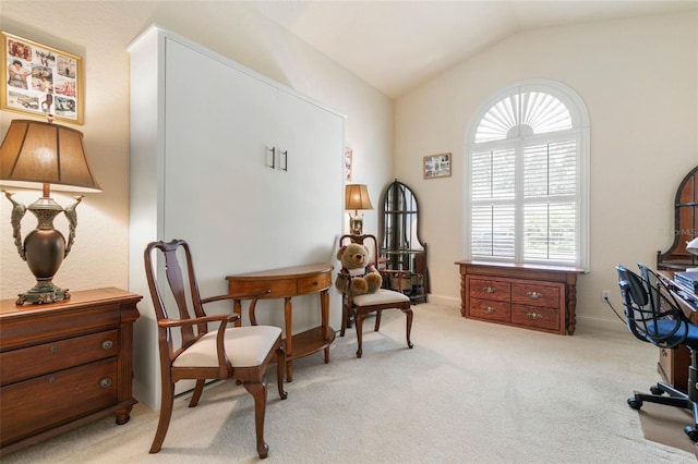 living area with vaulted ceiling and light colored carpet