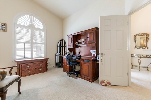 carpeted office space with vaulted ceiling