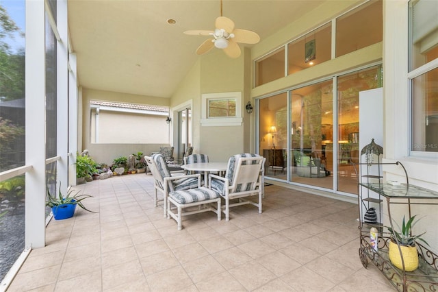 sunroom with ceiling fan and lofted ceiling