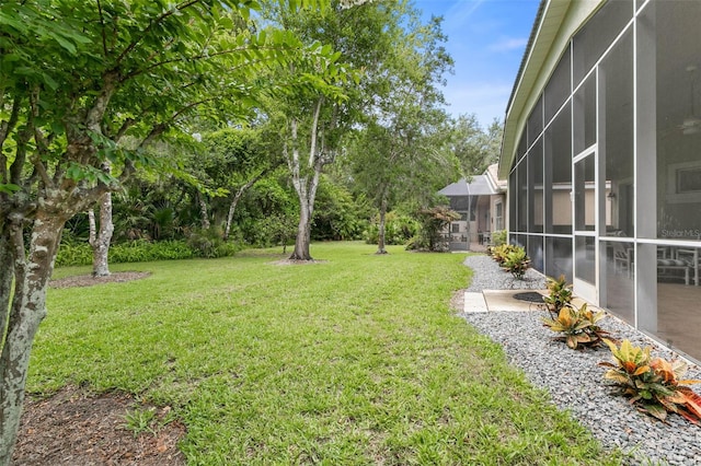 view of yard featuring a patio area and a lanai