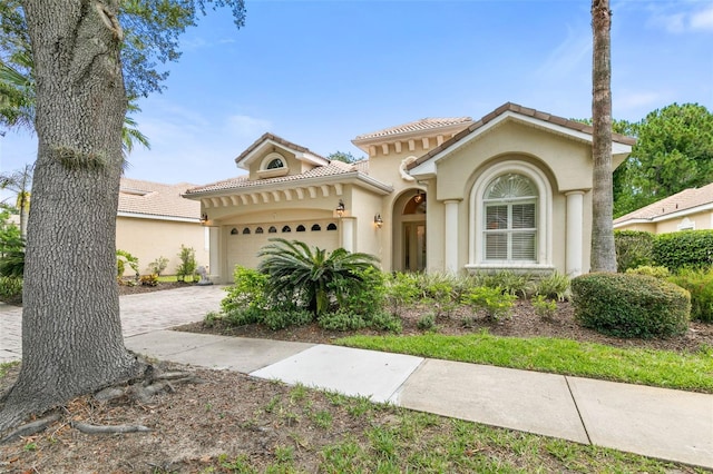 mediterranean / spanish-style home with a garage