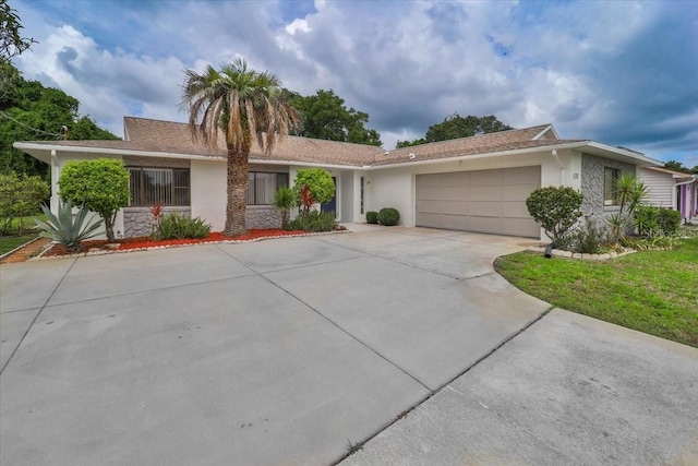 ranch-style house featuring a garage and a front yard