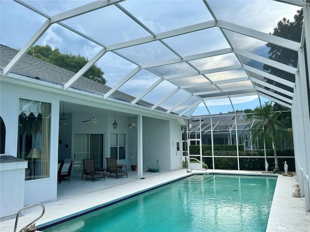 view of pool featuring a lanai, ceiling fan, and a patio area