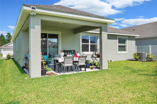 rear view of property with a patio area, a yard, and central AC unit