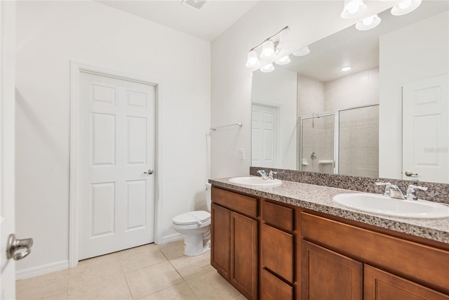 bathroom featuring tile patterned floors, vanity, toilet, and walk in shower