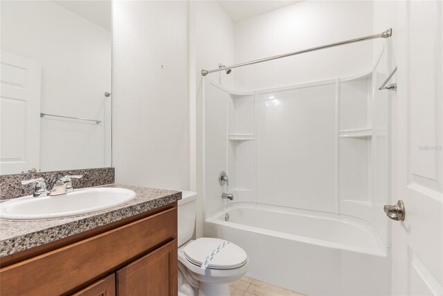 full bathroom with tile patterned floors, toilet, vanity, and washtub / shower combination