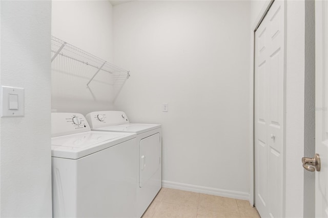 clothes washing area with washing machine and dryer