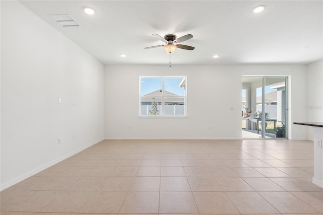 unfurnished room featuring light tile patterned floors and ceiling fan