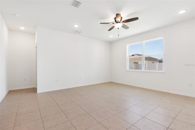 spare room featuring light tile patterned floors and ceiling fan