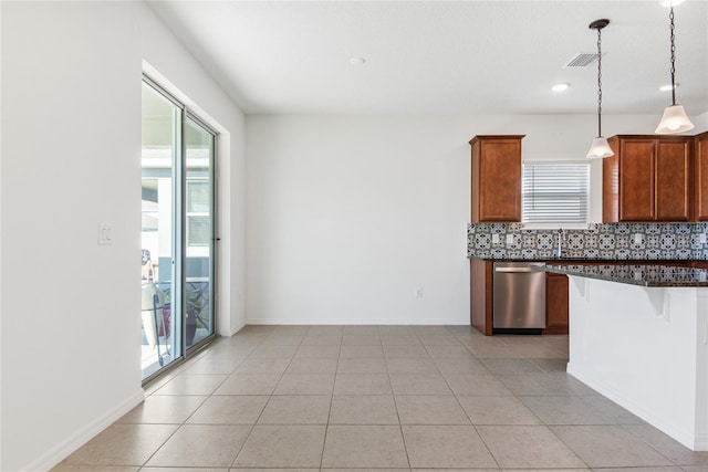 kitchen featuring dishwasher, sink, hanging light fixtures, decorative backsplash, and light tile patterned floors