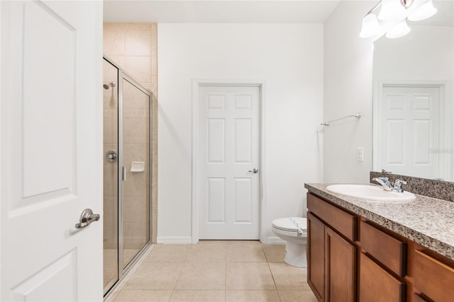 bathroom featuring tile patterned flooring, vanity, toilet, and a shower with shower door