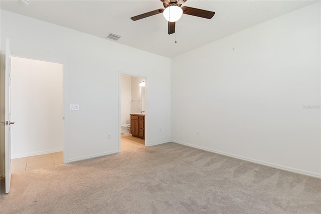 spare room with ceiling fan and light carpet