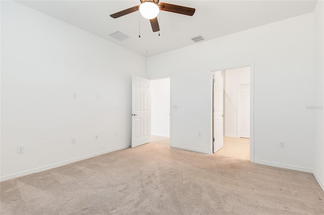 carpeted spare room featuring ceiling fan