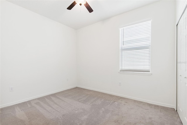 carpeted empty room with ceiling fan