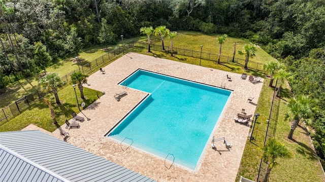 view of pool featuring a patio area and a yard