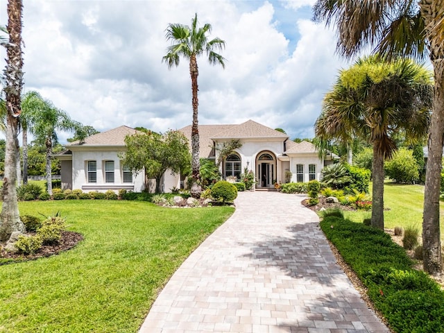 mediterranean / spanish-style home with a front yard