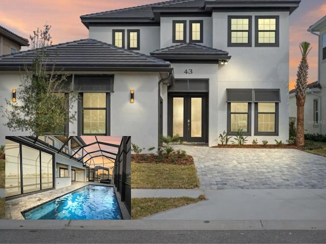 back house at dusk featuring french doors