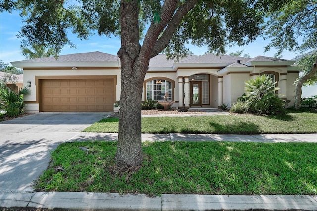 view of front of house featuring a garage and a front lawn