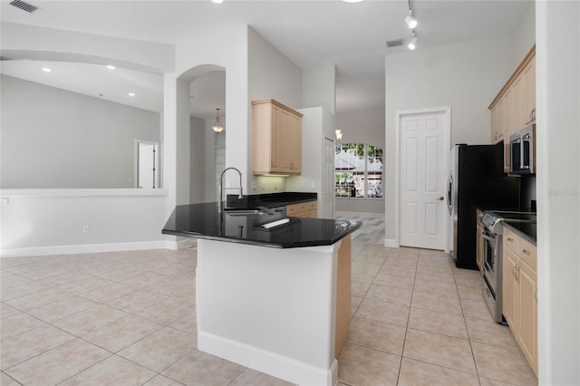 kitchen featuring kitchen peninsula, appliances with stainless steel finishes, light brown cabinets, and light tile patterned flooring