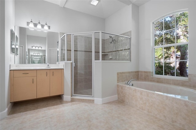 bathroom with tile patterned flooring, vanity, and shower with separate bathtub