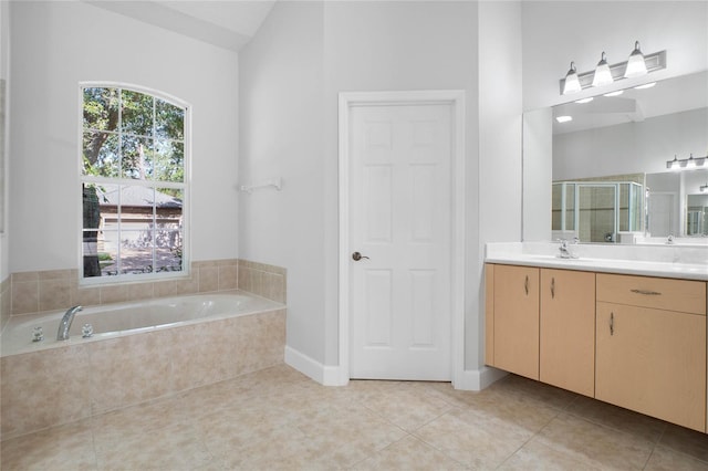 bathroom featuring tile patterned flooring, vanity, plus walk in shower, and vaulted ceiling