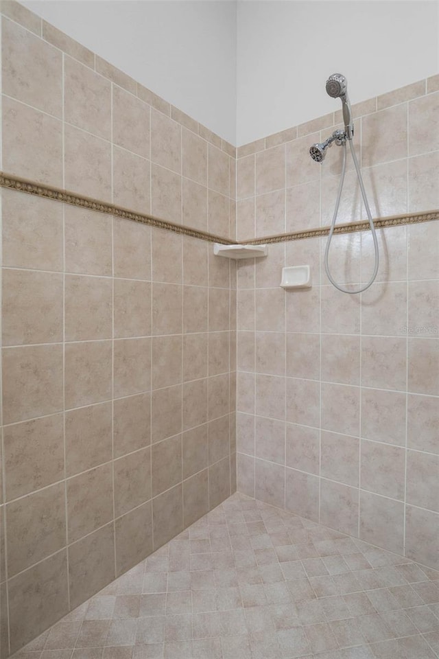 bathroom with a tile shower