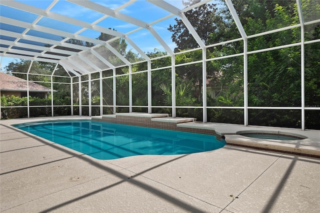 view of swimming pool featuring an in ground hot tub, a lanai, and a patio area