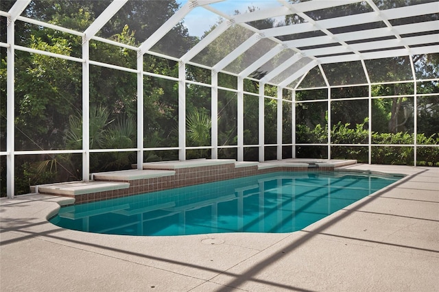 view of swimming pool featuring a lanai and a patio