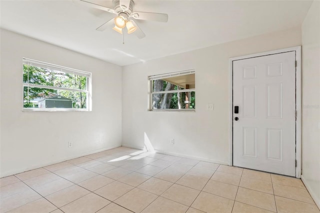 unfurnished room featuring ceiling fan and light tile patterned floors