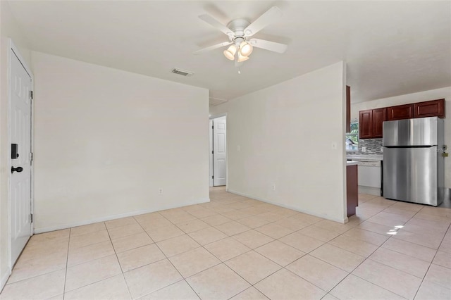 tiled spare room with ceiling fan