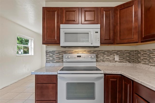 kitchen with white appliances, tasteful backsplash, and light tile patterned flooring