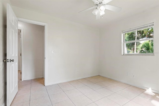 spare room featuring ceiling fan and light tile patterned floors