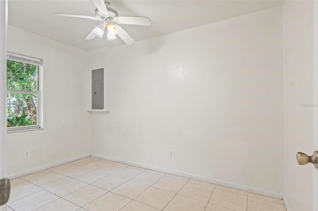 spare room featuring light tile patterned floors, electric panel, and ceiling fan