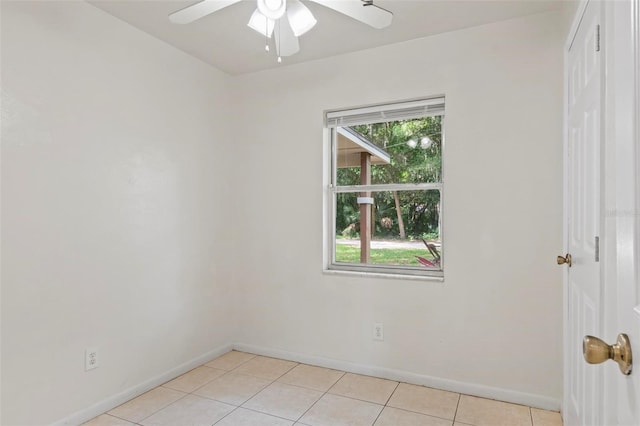 unfurnished room with ceiling fan and light tile patterned floors