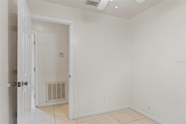 unfurnished room with ceiling fan and light tile patterned floors