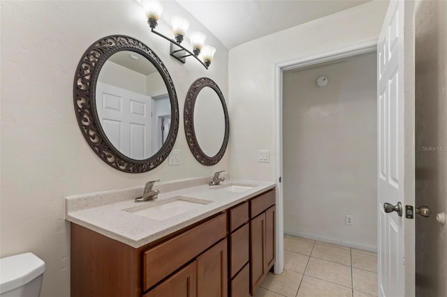 bathroom with tile patterned floors, vanity, and toilet