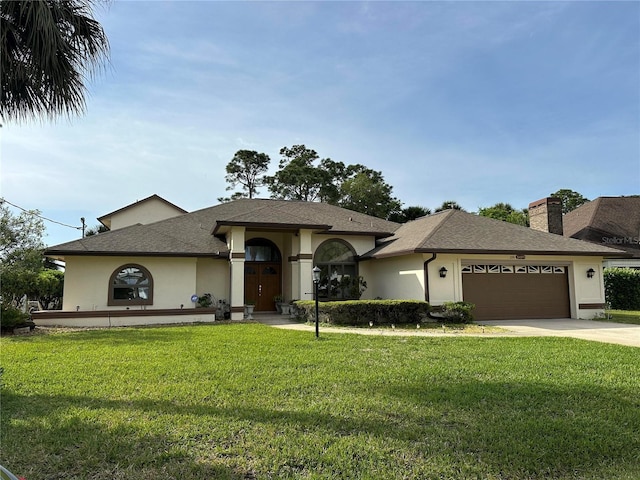 view of front of property with a garage and a front yard