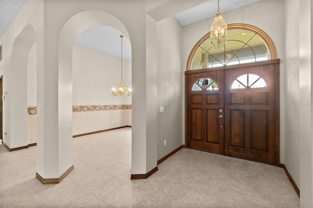 entryway with an inviting chandelier and a high ceiling