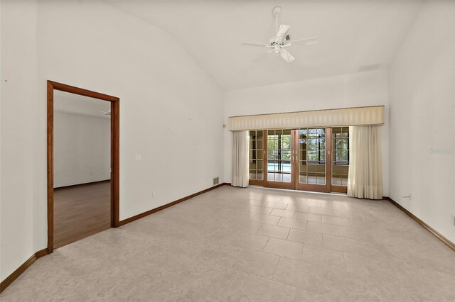 spare room with ceiling fan, light tile patterned floors, and high vaulted ceiling