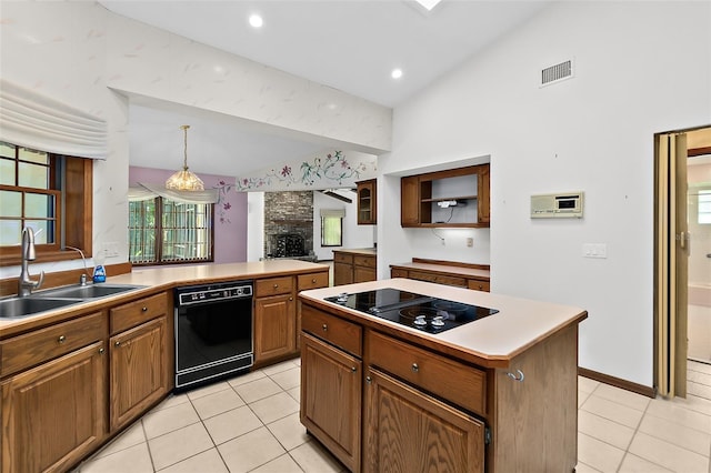 kitchen with sink, a center island, hanging light fixtures, light tile patterned floors, and black appliances