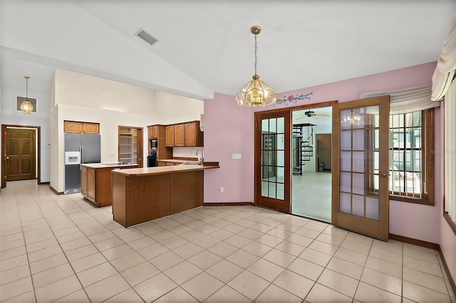 kitchen with french doors, sink, kitchen peninsula, pendant lighting, and stainless steel appliances