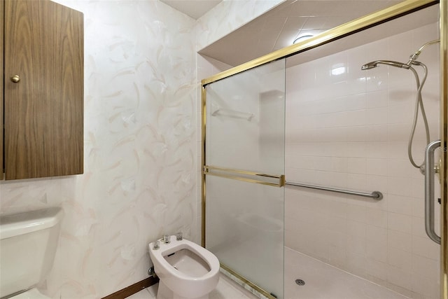 bathroom with a shower with door and a bidet