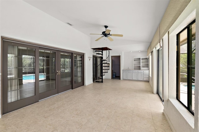 unfurnished sunroom with vaulted ceiling, ceiling fan, and french doors