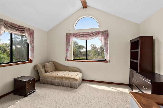 living area with light colored carpet, a healthy amount of sunlight, and vaulted ceiling with beams