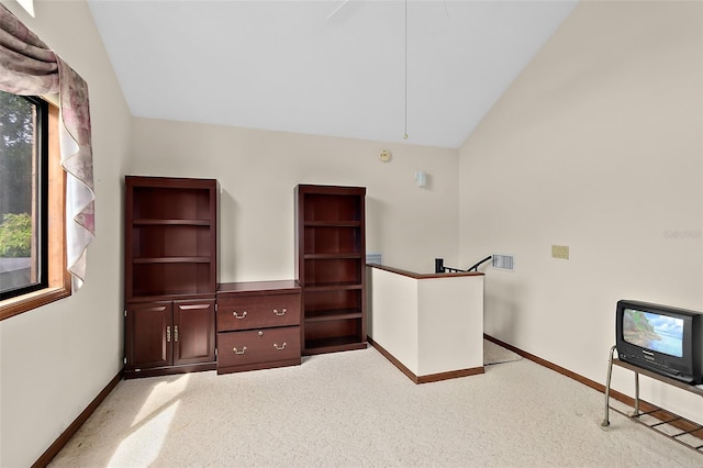 unfurnished bedroom featuring vaulted ceiling and light colored carpet