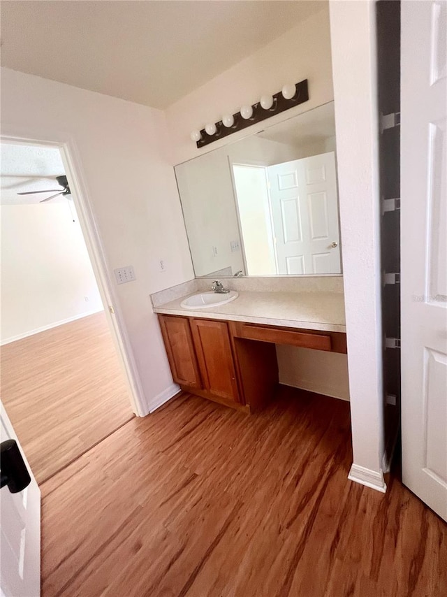 bathroom featuring vanity, wood-type flooring, and ceiling fan