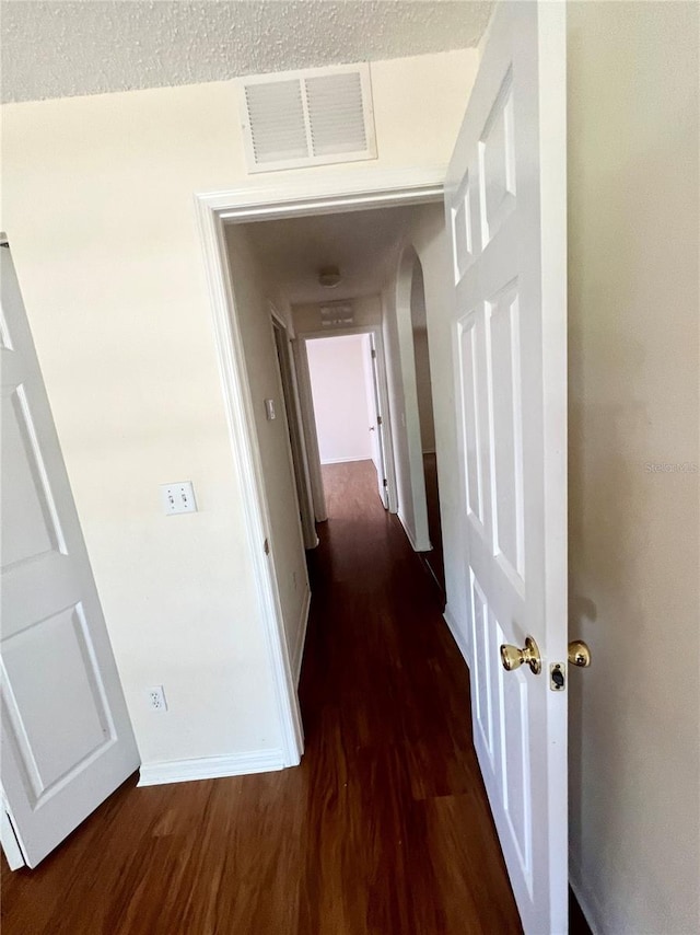 hall with dark hardwood / wood-style floors