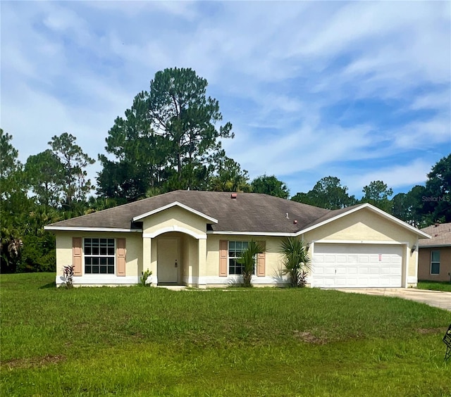 ranch-style house featuring a garage and a front yard