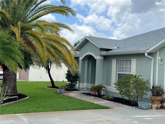 property entrance with a lawn