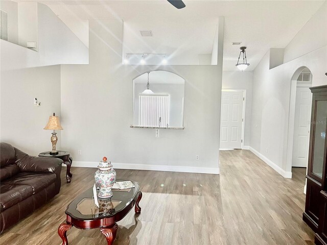 living room featuring hardwood / wood-style floors and high vaulted ceiling